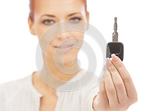 Portrait of a young woman holding a car key