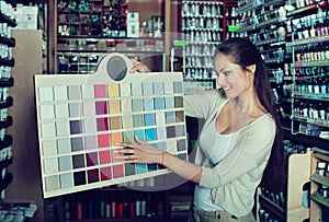 Portrait of young woman holding color sample palette