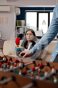 Portrait of young woman holding glass of beer at after work celebration