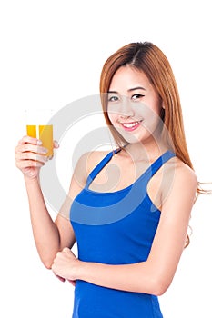 Portrait of young woman holding glass of orange juice