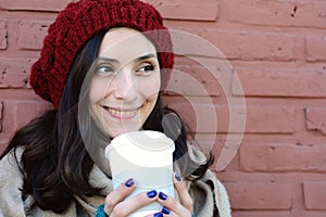 Portrait of young woman holding hot coffee