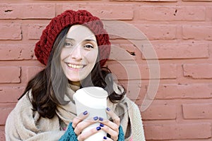 Portrait of young woman holding hot coffee
