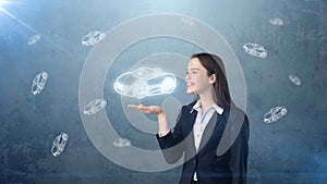 Portrait of young woman holding painted cartoon car on the open hand palm, drawn studio background. Business concept.