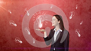 Portrait of young woman holding painted glowing lamp on the open hand palm, drawn studio background. Business concept.