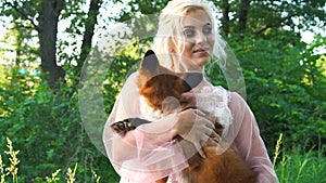 Portrait Of A Young Woman holding a Red Fox in her arms. With copy space