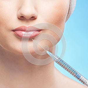 Portrait of a young woman holding a syringe