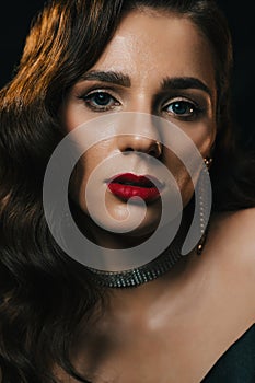 Portrait of a young woman in Hollywood retro noir style. A beautiful brunette girl with a hairstyle and makeup
