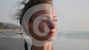 Portrait of young woman with Indian bindi looking to camera