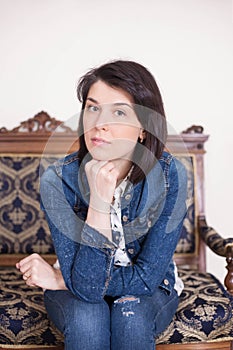 Portrait of a young woman in the interior. Emotions of thoughtfulness, seriousness photo