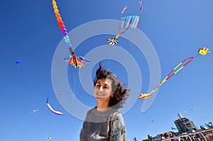 A portrait of a young woman with the kites. Festival of the winds, Bondi beach, Sydney, Australia