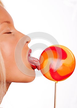 Portrait of young woman lick lollipop