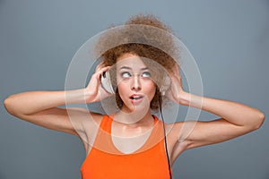 Portrait of young woman listening to music with headphones