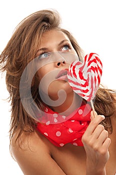 Portrait of young woman with lollipop