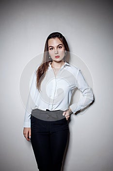 Portrait of young woman with long black hair in business wear.