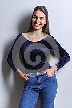 Portrait of young woman looking at camera on white background