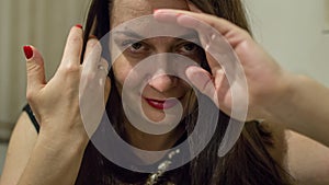 Portrait of a young woman looking to camera.