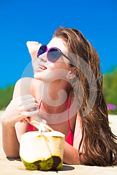 Portrait of young woman lying in straw hat in