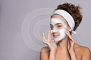 A portrait of a young woman with mask in a studio, beauty and skin care.