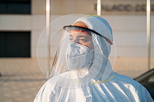 Portrait of a young woman medical worker uses a PCR test on a person inside a car