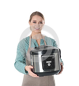 Portrait of young woman with modern multi cooker
