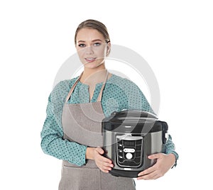Portrait of young woman with modern multi cooker