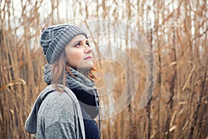 Portrait of young woman outdoors with reeds in the background