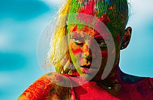 Portrait of young woman with paint make-up. Color face with colorful holi splash. Concept for Indian festival Holi.