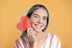 Portrait of young woman with paper heart