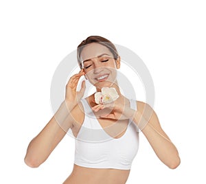 Portrait of young woman with perfect smooth skin and flower on white background