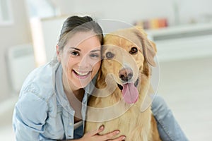 Portrait of young woman petting her dog