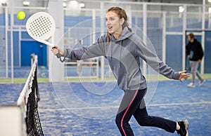 Portrait of a young woman playing padel