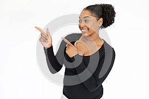 Portrait of young woman pointing at something and sneering photo