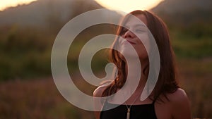 A portrait of a young woman posing with a grass straw and smiling