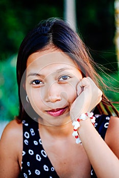 Portrait of a young woman with positive attitude smiling