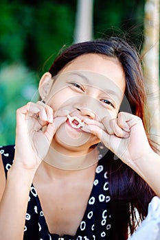 Portrait of a young woman with positive attitude smiling