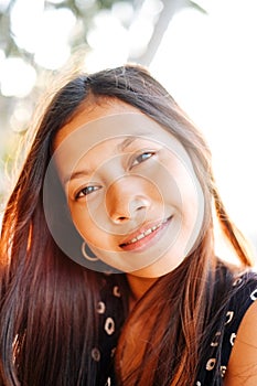 Portrait of a young woman with positive attitude smiling