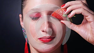 Portrait of young woman with red eyes and lips