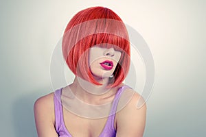 Portrait young woman with red hair and bang covering her eyes