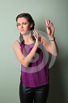 Portrait of young woman rejecting something on color background