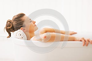 Portrait of young woman relaxing in bathtub