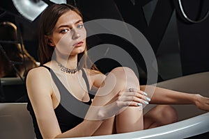 Portrait of a young woman relaxing in the bathtub, organic skin-care at the spa, wellbeing and self-care concept