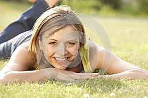 Portrait of young woman relaxing in countryside