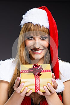 Portrait of young, woman Santa with gift boxes