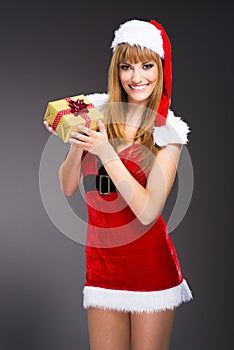 Portrait of young, woman Santa with gift boxes