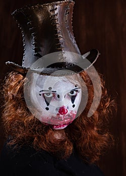 Portriat of a Young woman ins scary clown make up.
