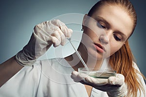 Portrait of young woman - scientist with dropper working