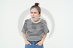 Portrait of young woman with shocked, angry face expression, hear something disappointing, shows negative, frustrated