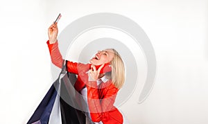 Portrait of young woman with shopping bags, mobile phone and credit card.