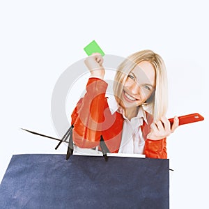 Portrait of young woman with shopping bags, mobile phone and credit card.