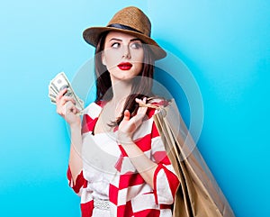 Portrait of the young woman with shopping bags and money